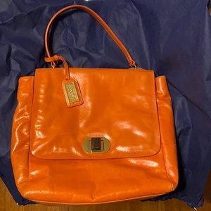 Orange/peach purse with beige interior.